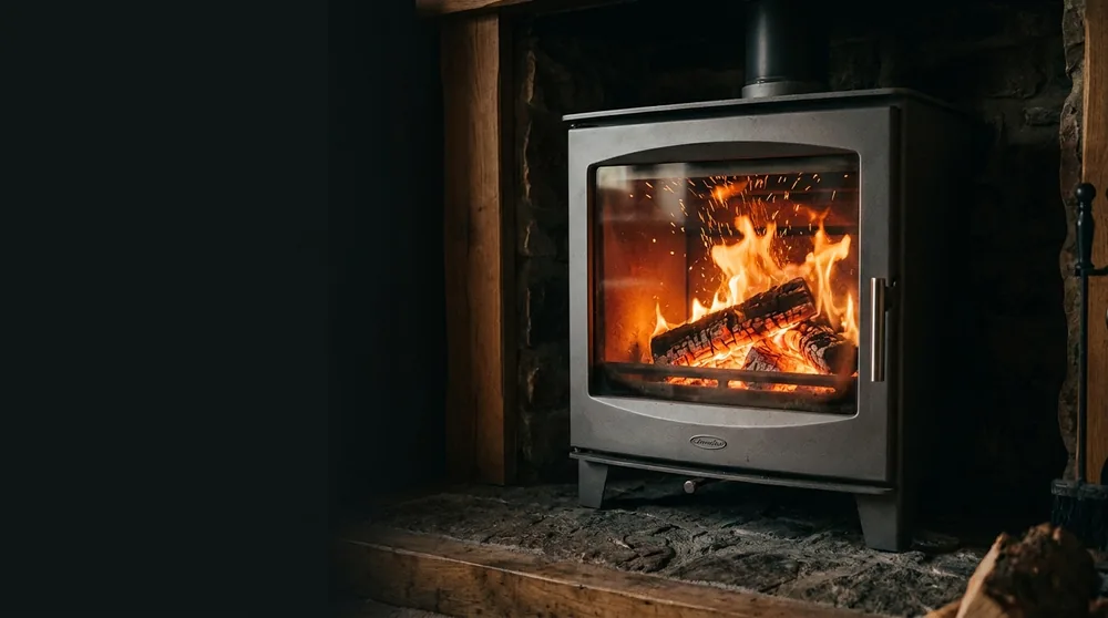 A fire burning in a stove with a glass door