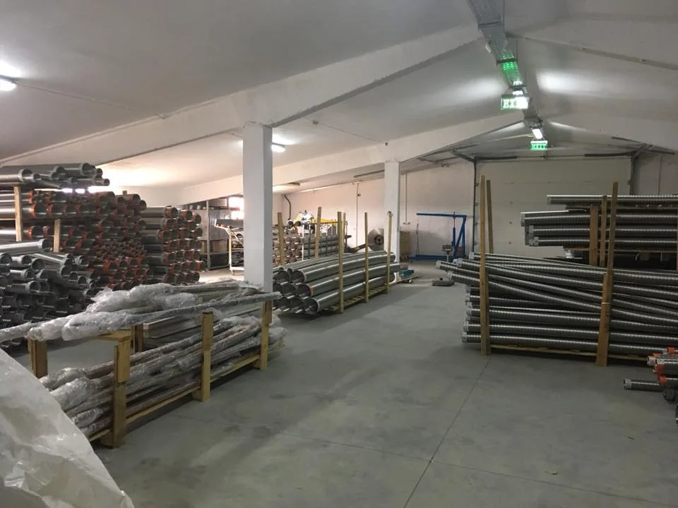 Metal pipes and profiles stacked in a storage hall