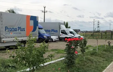 Three delivery vans in Promo Plus livery, parked